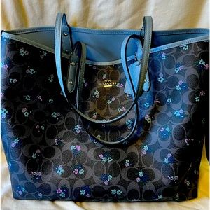 The Coach Reversible Tote. Solid light blue on one side and dark blue.